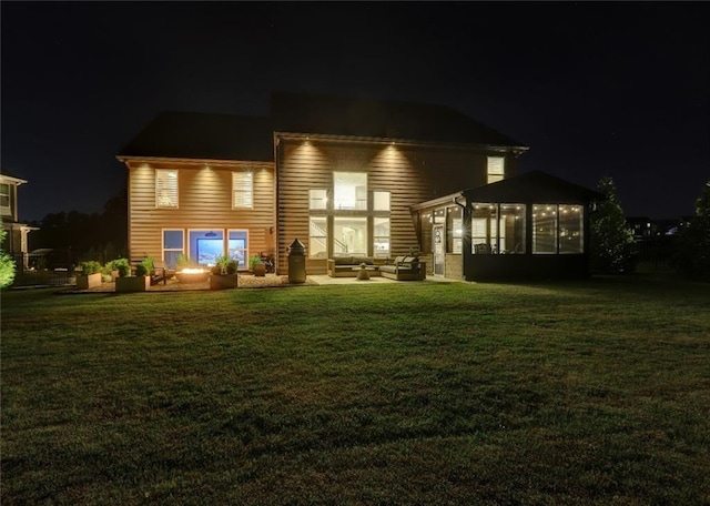 13 Clearwater Ct, Hoschton, GA 30548 - back of house at twilight featuring an outdoor living space, a sunroom, a lawn, and a patio area