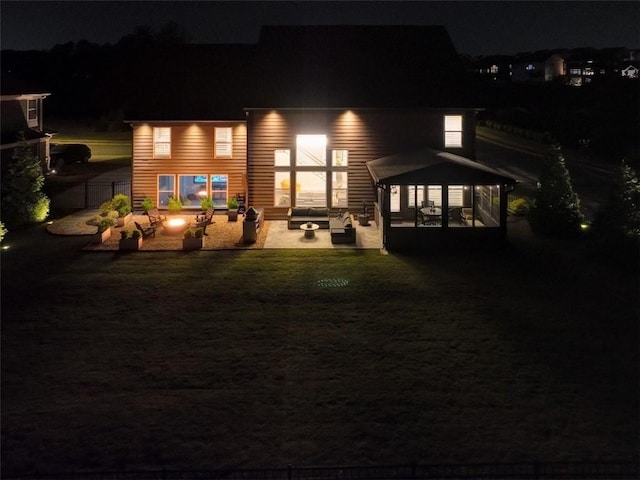 13 Clearwater Ct, Hoschton, GA 30548 - back of house at night with a patio and an outdoor hangout area
