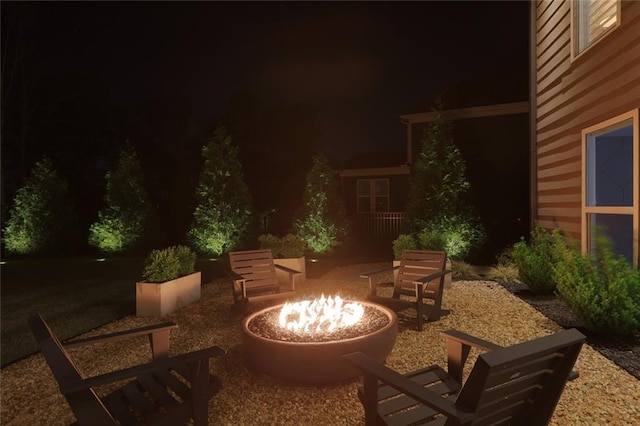 13 Clearwater Ct, Hoschton, GA 30548 - patio at night featuring a fire pit and a patio area