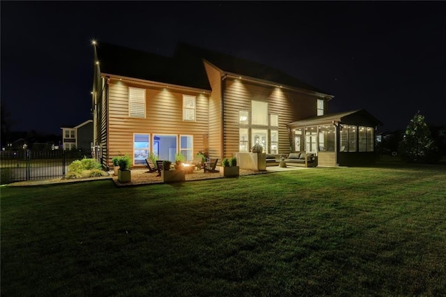 13 Clearwater Ct, Hoschton, GA 30548 - back of house at night featuring outdoor lounge area, a sunroom, and a patio