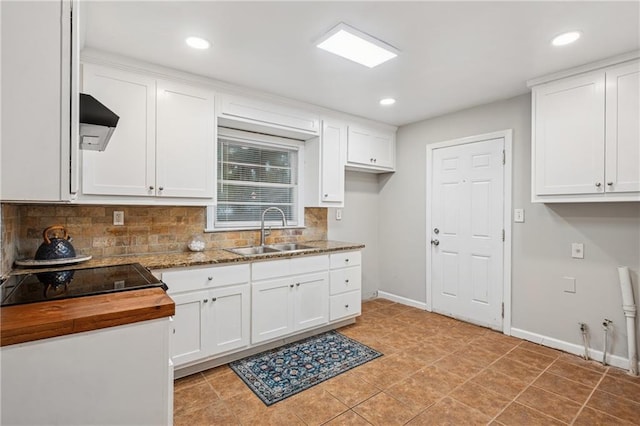 2858 Valley Ridge Dr, Decatur, GA 30032 - kitchen featuring a sink, tasteful backsplash, white cabinets, butcher block countertops, and baseboards