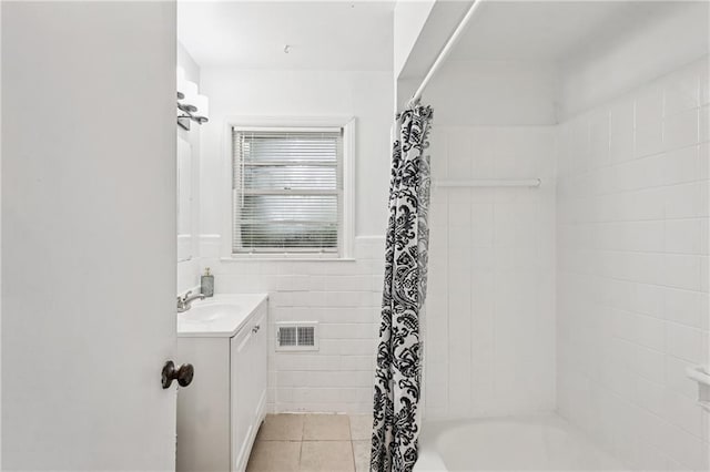 2858 Valley Ridge Dr, Decatur, GA 30032 - bathroom featuring vanity, tile patterned floors, shower / tub combo, and tile walls