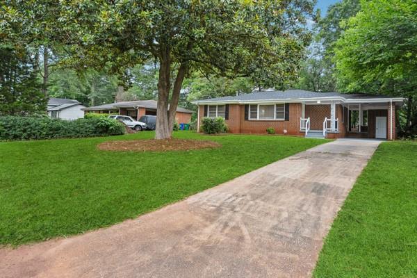 2858 Valley Ridge Dr, Decatur, GA 30032 - ranch-style house featuring concrete driveway, a front lawn, and an attached carport