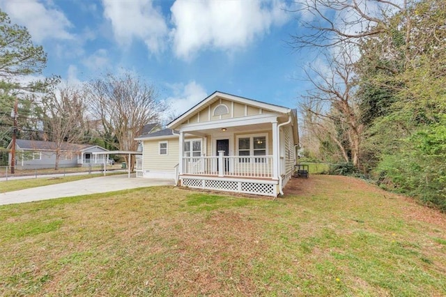 bungalow-style house featuring a porch, concrete driveway, and a front yard