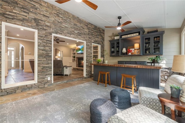 3578 Hope Rd, Cumming, GA 30041 - bar featuring arched walkways, a fireplace, and a ceiling fan