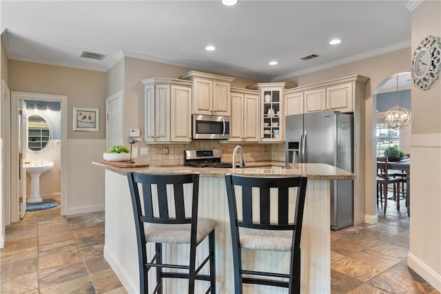3578 Hope Rd, Cumming, GA 30041 - kitchen featuring a breakfast bar, stone tile flooring, light stone countertops, visible vents, and stainless steel appliances