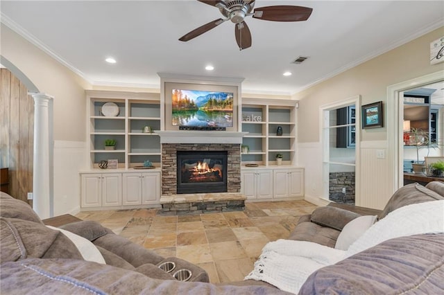 3578 Hope Rd, Cumming, GA 30041 - living room with ornamental molding, a fireplace, a ceiling fan, visible vents, and arched walkways