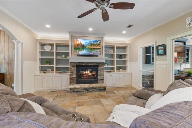 3578 Hope Rd, Cumming, GA 30041 - living room featuring visible vents, arched walkways, a ceiling fan, a fireplace, and crown molding