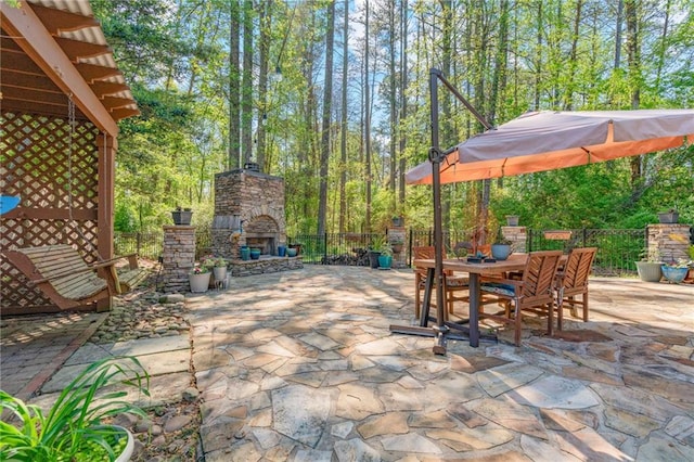 3578 Hope Rd, Cumming, GA 30041 - view of patio / terrace with outdoor dining space, an outdoor stone fireplace, and fence