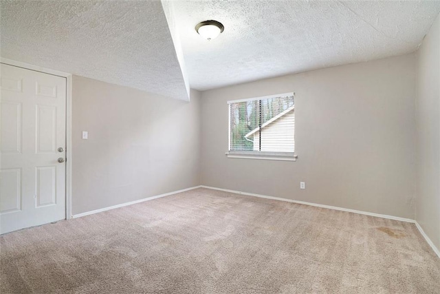 empty room featuring carpet flooring and a textured ceiling