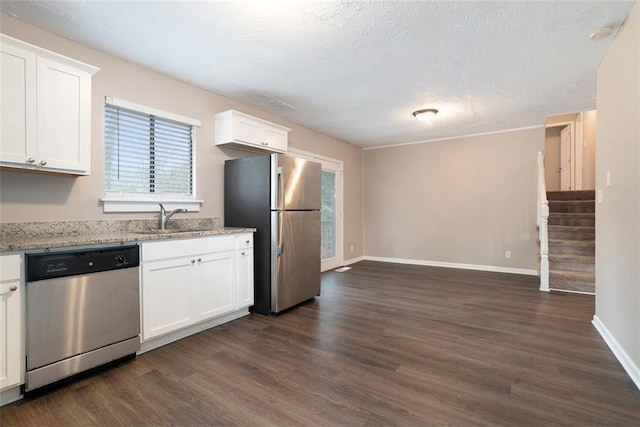 kitchen with white cabinetry, dark wood-type flooring, and appliances with stainless steel finishes