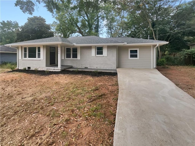 single story home featuring brick siding and roof with shingles