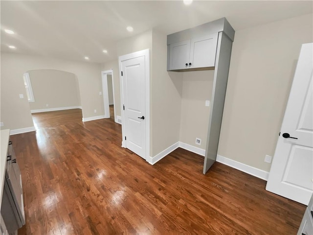 1955 S Columbia Pl, Decatur, GA 30032 - laundry area with baseboards, arched walkways, and dark wood-style flooring