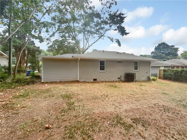 1955 S Columbia Pl, Decatur, GA 30032 - rear view of property featuring central AC unit, fence, and crawl space