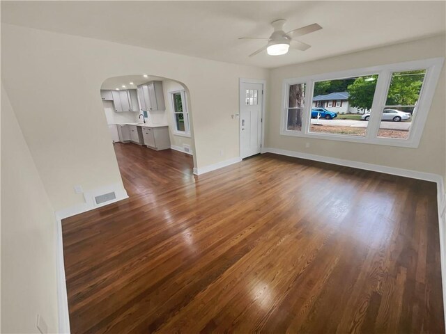 spare room with sink, ceiling fan, and dark hardwood / wood-style floors