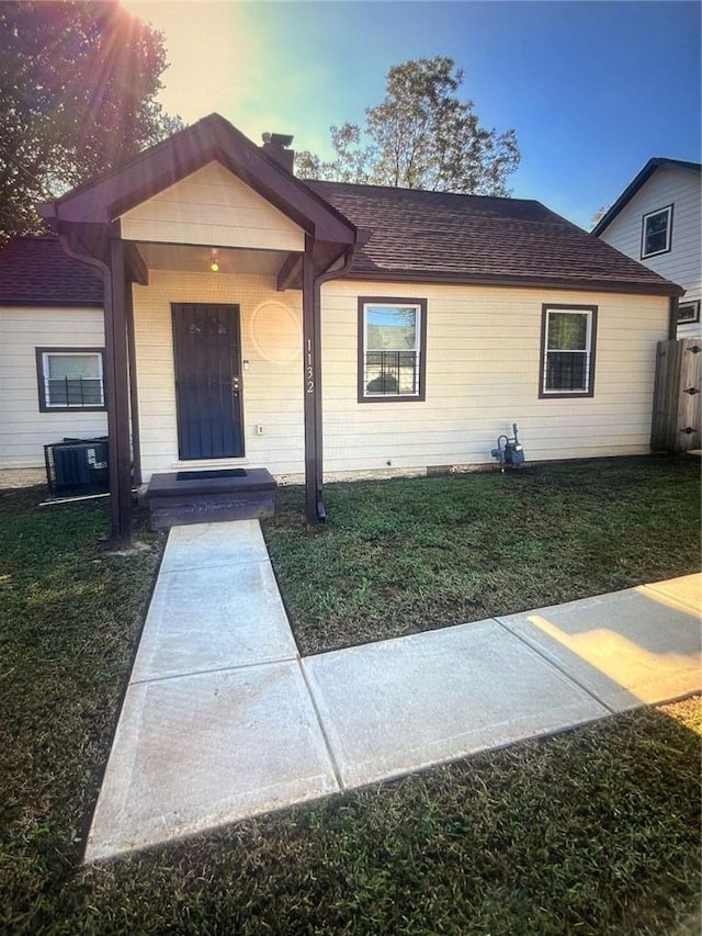 1132 SE Oak Knoll Ter SE, Atlanta, GA 30315 - view of front of property with a front lawn, a shingled roof, and central AC