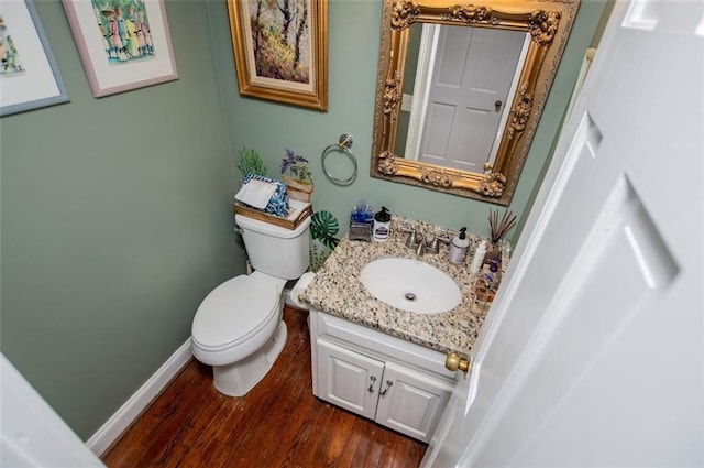 3187 Oak Grove Church Rd, Carrollton, GA 30117 - bathroom with vanity, toilet, wood finished floors, and baseboards