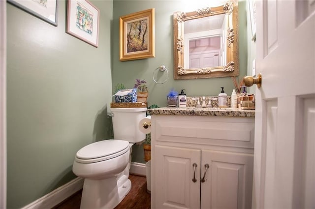 3187 Oak Grove Church Rd, Carrollton, GA 30117 - half bath with toilet, vanity, baseboards, and wood finished floors