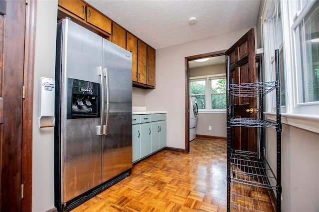 3187 Oak Grove Church Rd, Carrollton, GA 30117 - kitchen with stainless steel refrigerator with ice dispenser, baseboards, light countertops, a textured ceiling, and washer / clothes dryer