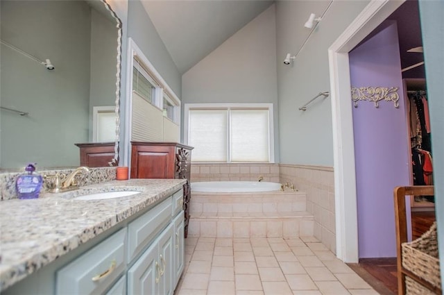 3187 Oak Grove Church Rd, Carrollton, GA 30117 - full bath with vanity, a bath, lofted ceiling, tile patterned flooring, and a spacious closet