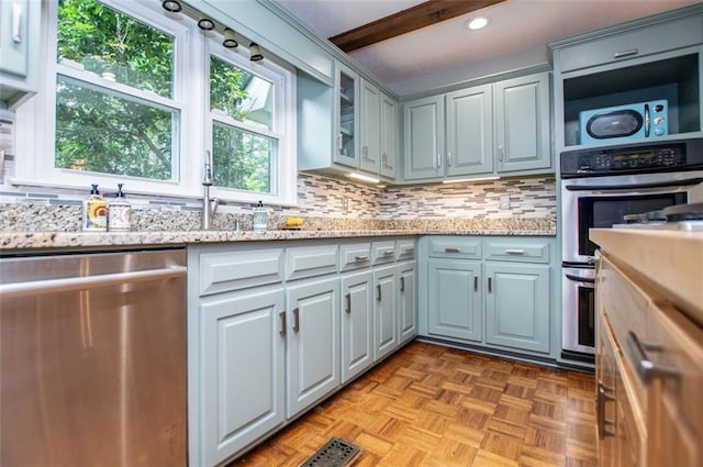 3187 Oak Grove Church Rd, Carrollton, GA 30117 - kitchen with dishwasher, decorative backsplash, light stone counters, glass insert cabinets, and recessed lighting