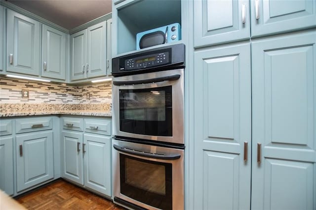 3187 Oak Grove Church Rd, Carrollton, GA 30117 - kitchen featuring stainless steel double oven, tasteful backsplash, and light stone countertops