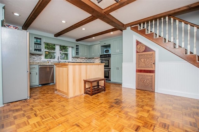 3187 Oak Grove Church Rd, Carrollton, GA 30117 - kitchen with appliances with stainless steel finishes, open shelves, tasteful backsplash, beam ceiling, and a center island
