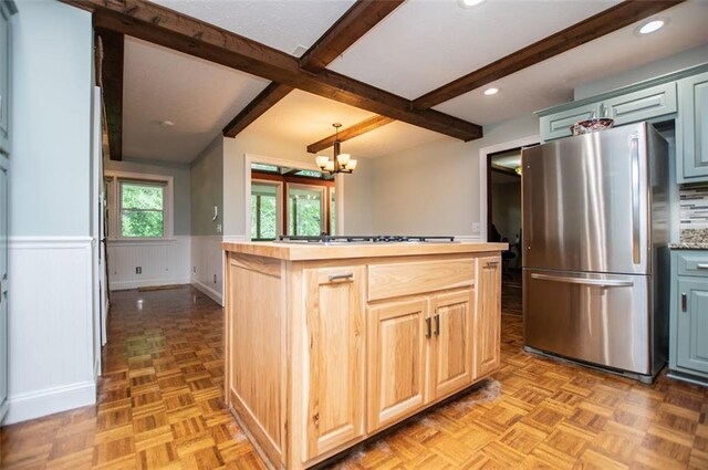 3187 Oak Grove Church Rd, Carrollton, GA 30117 - kitchen featuring freestanding refrigerator, beam ceiling, a wainscoted wall, a chandelier, and white gas cooktop