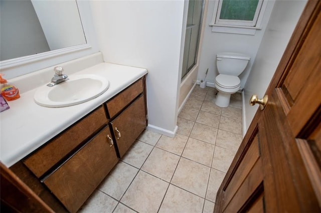 3187 Oak Grove Church Rd, Carrollton, GA 30117 - bathroom featuring tile patterned flooring, vanity, toilet, combined bath / shower with glass door, and baseboards