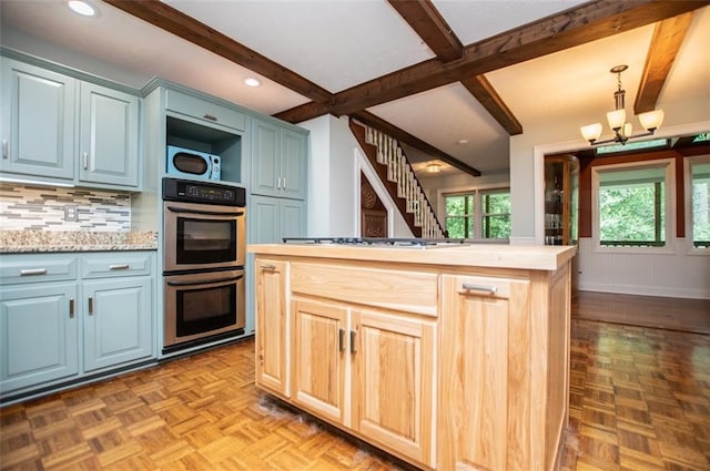 3187 Oak Grove Church Rd, Carrollton, GA 30117 - kitchen with stainless steel double oven, beamed ceiling, light countertops, white gas cooktop, and a chandelier