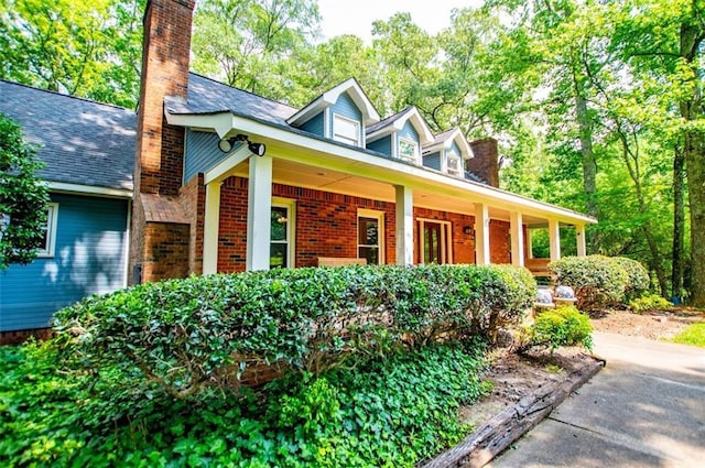 3187 Oak Grove Church Rd, Carrollton, GA 30117 - view of front of house featuring a porch, a chimney, and brick siding