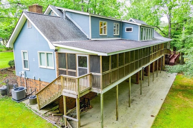 3187 Oak Grove Church Rd, Carrollton, GA 30117 - back of property with a shingled roof, a patio, a chimney, a sunroom, and stairway
