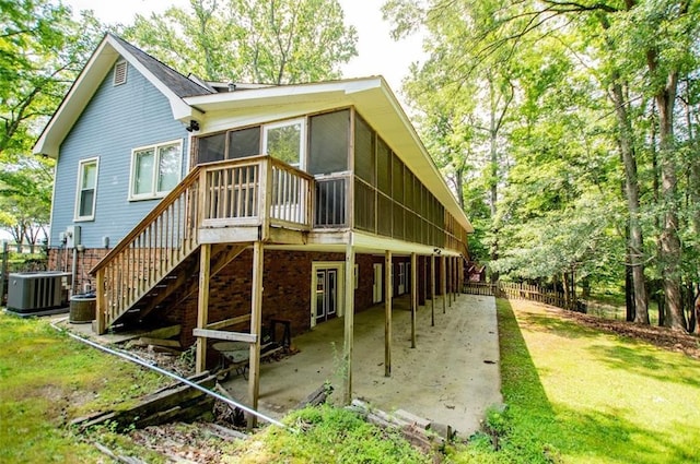 3187 Oak Grove Church Rd, Carrollton, GA 30117 - back of house featuring a sunroom, a patio area, central AC unit, and stairs