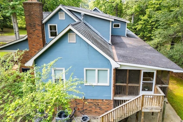 3187 Oak Grove Church Rd, Carrollton, GA 30117 - rear view of property with a chimney, a sunroom, stairs, and a shingled roof