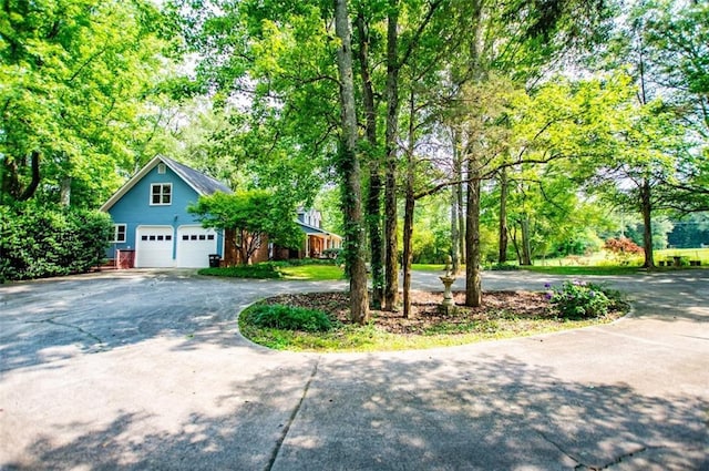3187 Oak Grove Church Rd, Carrollton, GA 30117 - view of front of home featuring curved driveway, a detached garage, and view of scattered trees