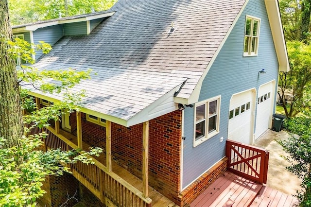3187 Oak Grove Church Rd, Carrollton, GA 30117 - view of side of home featuring a shingled roof, brick siding, a wooden deck, and a garage