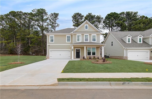 craftsman-style home featuring stone siding, central AC unit, an attached garage, a front lawn, and driveway