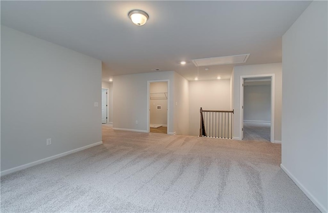 spare room featuring baseboards, carpet, recessed lighting, and attic access