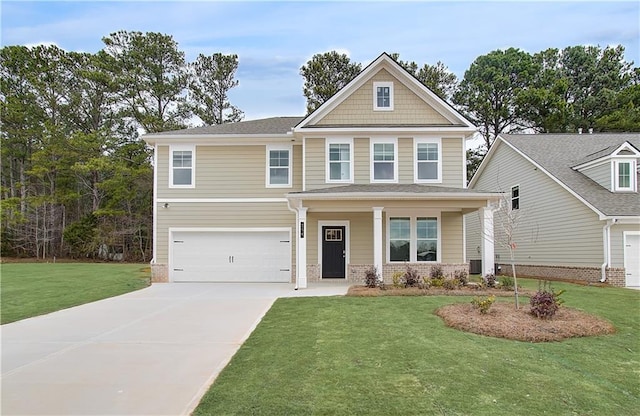 craftsman house featuring driveway, a garage, and a front lawn