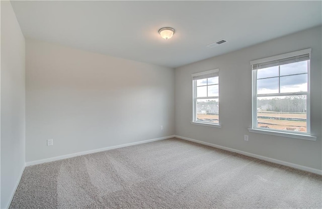 empty room with light carpet, baseboards, and visible vents