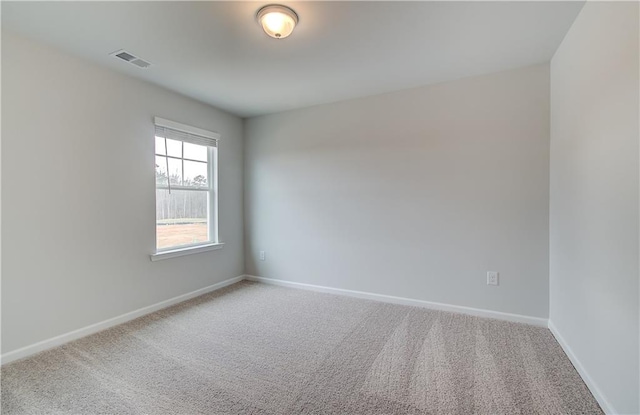 unfurnished room with baseboards, carpet flooring, and visible vents
