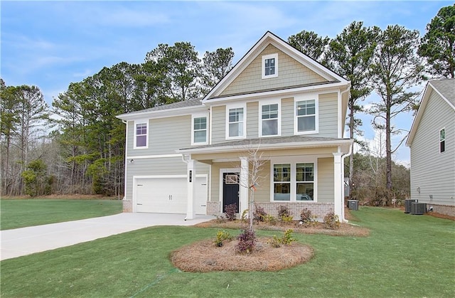 view of front facade with brick siding, a front yard, driveway, and a garage