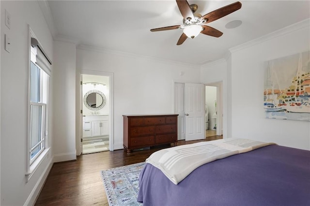 bedroom featuring crown molding, ceiling fan, dark hardwood / wood-style flooring, and ensuite bath