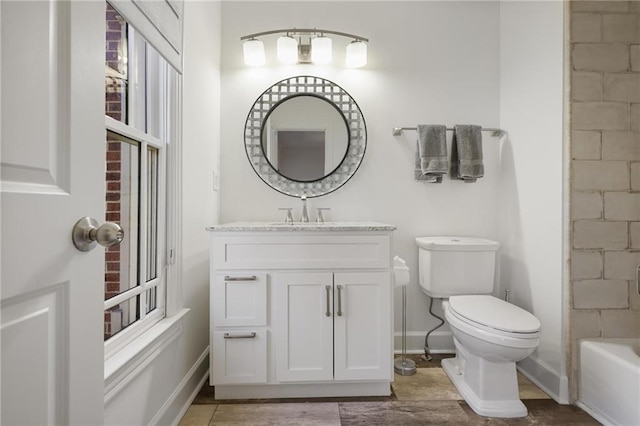 bathroom featuring vanity, wood-type flooring, and toilet