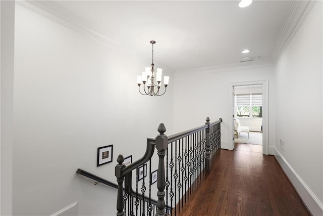 hall featuring an inviting chandelier, crown molding, and dark hardwood / wood-style floors