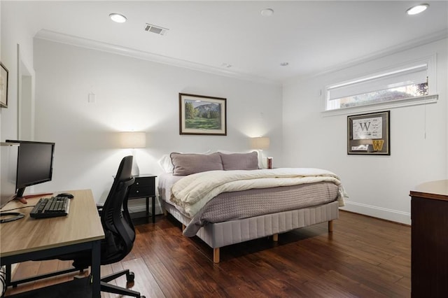 bedroom with dark hardwood / wood-style flooring and ornamental molding