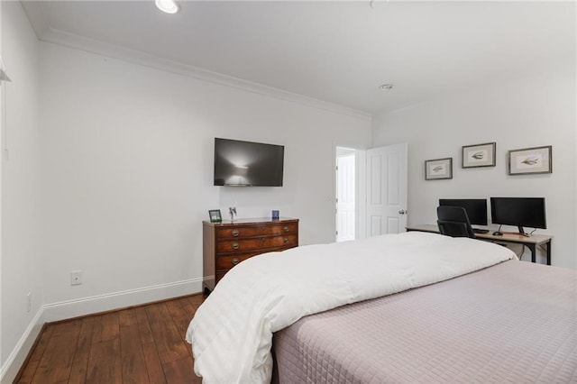 bedroom featuring crown molding and dark wood-type flooring