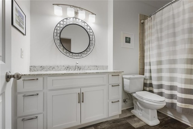 bathroom with vanity, a shower with curtain, and toilet