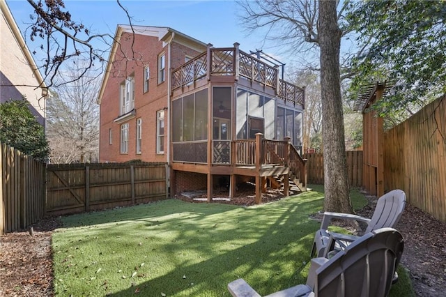 back of house with a sunroom, a yard, and a deck