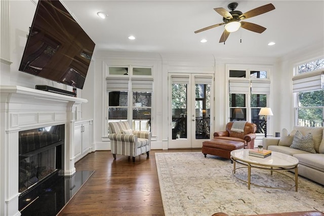 living room featuring ornamental molding, dark wood-type flooring, ceiling fan, and french doors